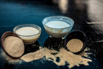 Key ingredients to make poppy seeds bread.loaf/dough nuts/muffins/cake on wooden surface which are poppy seeds along with its powder and milk.