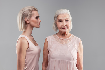 Old grey-haired woman with bob hairstyle looking directly into camera