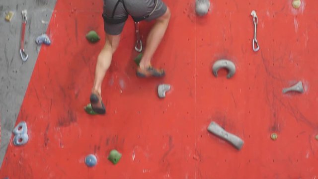 Conquering new peaks.young man trying to land on the floor safely after bouldering, slow motion