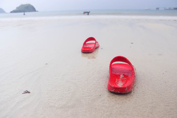 Shoes on the beach, the illustrations in the holiday by the sea, a tourist on holiday.