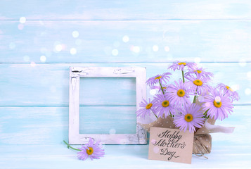 Chamomile, vintage photo frame in Shabby Chic style and greeting card for Mother's day on wooden wall background