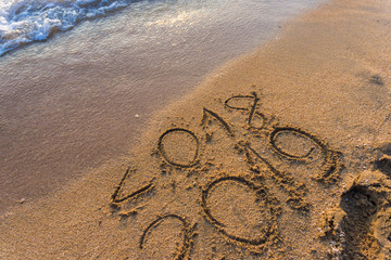 2019 Happy new year on seashore sand beach sunset colorful sky, Element of photo design