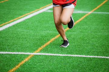 young sport girl running on sport field