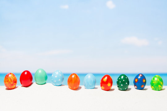 Easter On Tropical Beach Background. Eggs On The White Sand. Vacation And Travel Concept In Spring