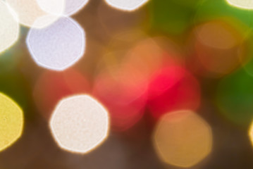 Close-up photo of lights of Christmas tree garlands in the form of defocus and bokeh