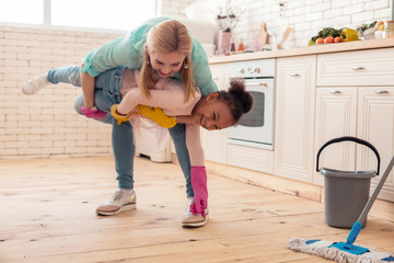 Beaming foster child laughing spending time with mom