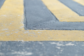 Yellow and Black diagonal line on the concrete street/road surface. abstract background texture