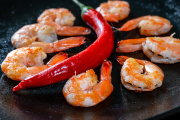 Grilled prawns with chili pepper. Royal delicious and beautiful shrimp. Flatley. Food background