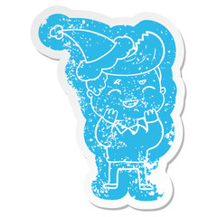 cartoon distressed sticker of a man laughing wearing santa hat