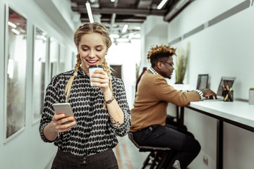 Positive lady with two braided returning from her break