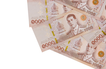 Pile of new one thousand Thai Baht banknotes, isolated on white background. Business and finance concept.