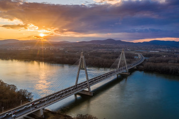 Budapest, Hungary - Aerial view of Megyeri Bridge over River Danube at sunset with heavy traffic and beautiful sky and clouds