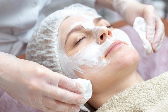 Beautiful woman with a facial mask at a beauty salon