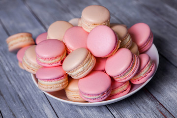 Fototapeta na wymiar Macaron cookies in white bowl Sweet and colorful french macaroons