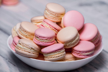 Macaron cookies in white bowl Sweet and colorful french macaroons Close up colorful macarons dessert with vintage pastel tones