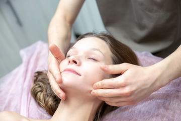 Obraz na płótnie Canvas A facial massage at a spa salon