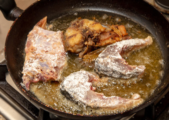 Fish is fried in a frying pan