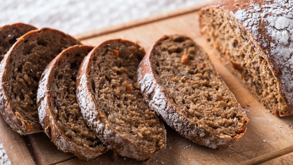 Sliced  bread on wooden board. Fresh homemade bread. Closeup