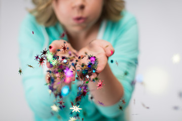 Close up of girl blowing glitter