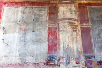 The city of Pompeii buried under a layer of ash by the volcano Mount Vesuvius. Murals on the walls