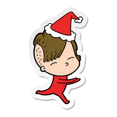 sticker cartoon of a girl in onesie wearing santa hat