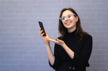 Young businesswoman is showing something on the phone