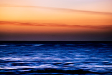 Fototapeta premium Water with stretch movement motion effect and coloured sky - sunset time with touristic and vacation concept