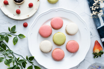 Macaron or French macaroon cookies dessert. Set on cafe table.