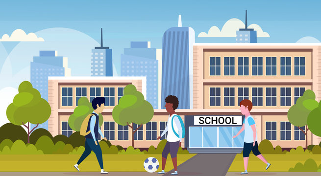 mix race schoolgirls playing football in front of school building primary schoolchildren having fun back to school concept cityscape background flat full length horizontal