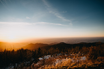 Obraz premium view from a mountain at sunset in winter with warm colors