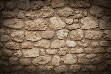 Background of stone wall texture with vignette