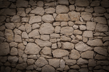 Background of stone wall texture with vignette