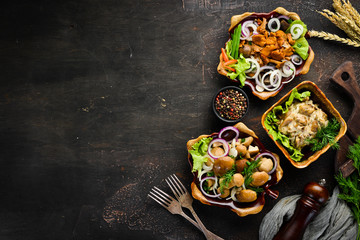 Set Marinated mushrooms with onions and spices in a plate. on rustic background, top view, banner.