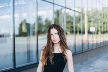 Cute cheerful portrait of young teenage girl outdoors in the street . Emotions, portrait, beauty concept