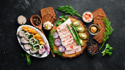 Dishes Ukrainian Traditional Cuisine. Fish, lard, bread and mustard. On the old background. free copying space.