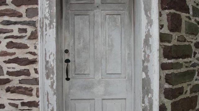 Old white colonial door with brick wall straight on