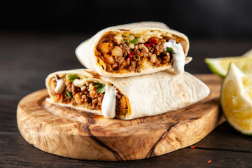 Mexican burrito with beef, beans and sour cream
