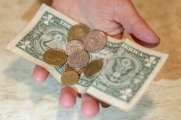 Various random cash dollar bills and american coins scattered.