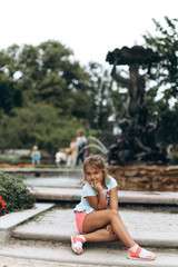 Adorable little girl walking in old town in Riga in summer. Childhood, travelling concept