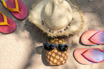 Summer vacation concept straw hat , pineapple fruit with sunglasses and  flip flop sandals  on...