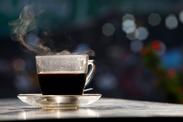 Beautiful steam over a cup of coffee in a morning