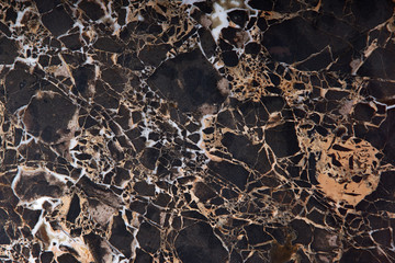 Brown marble with yellow and white veins, called Emperador gold