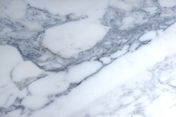 A beautiful background of natural stone, light marble with a gray pattern, is called Arabescato