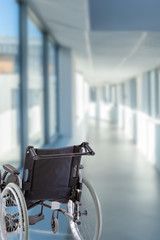 Wheelchair in the hospital in the corridor in front of a door