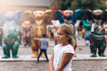 Little adorable cute girl in the street walking. Urban, vacation, travel, childhood concept