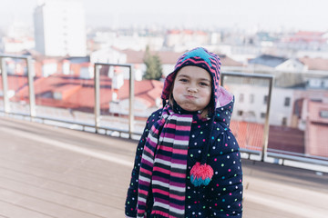 Close up outdoor portrait of young baby girl in hat. Childhood, happiness, joy concept