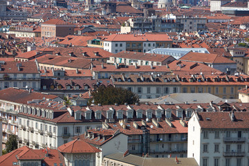 Fototapeta na wymiar Turin, Italian city rooftops and buildings background view in a sunny summer day