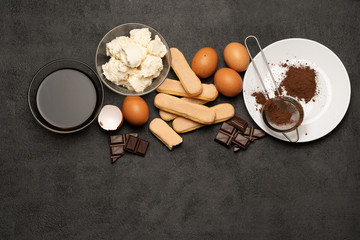 Ingredients for cooking tiramisu - Savoiardi biscuit cookies, mascarpone, cream, sugar, cocoa, coffee and egg