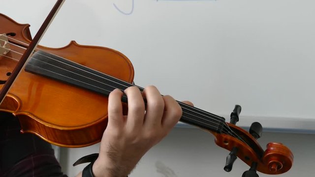 violin teacher playing the violin, playing the turkish style violin,