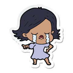 sticker of a cartoon girl crying and pointing